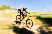 Biker in action on a dirt track with a blurred background