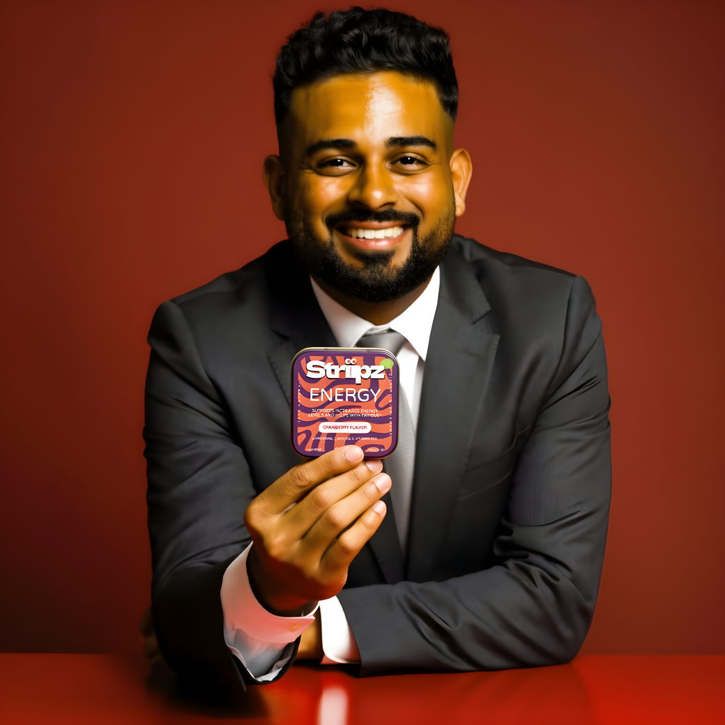 Man in a suit holding a Stripoz Energy product against a red background